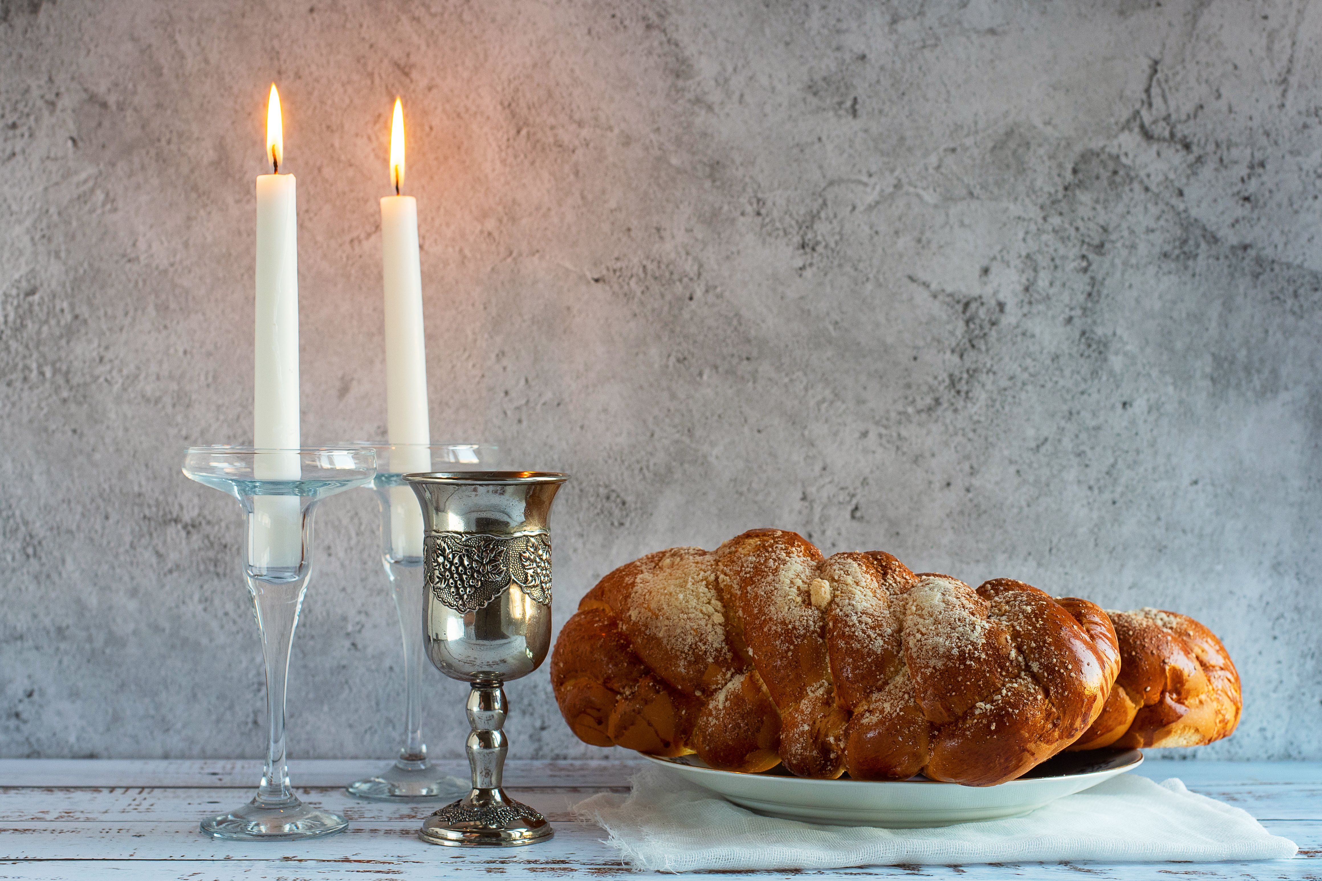 shabbat-shalom-challah-bread-shabbat-wine-candles-wooden-table.jpg