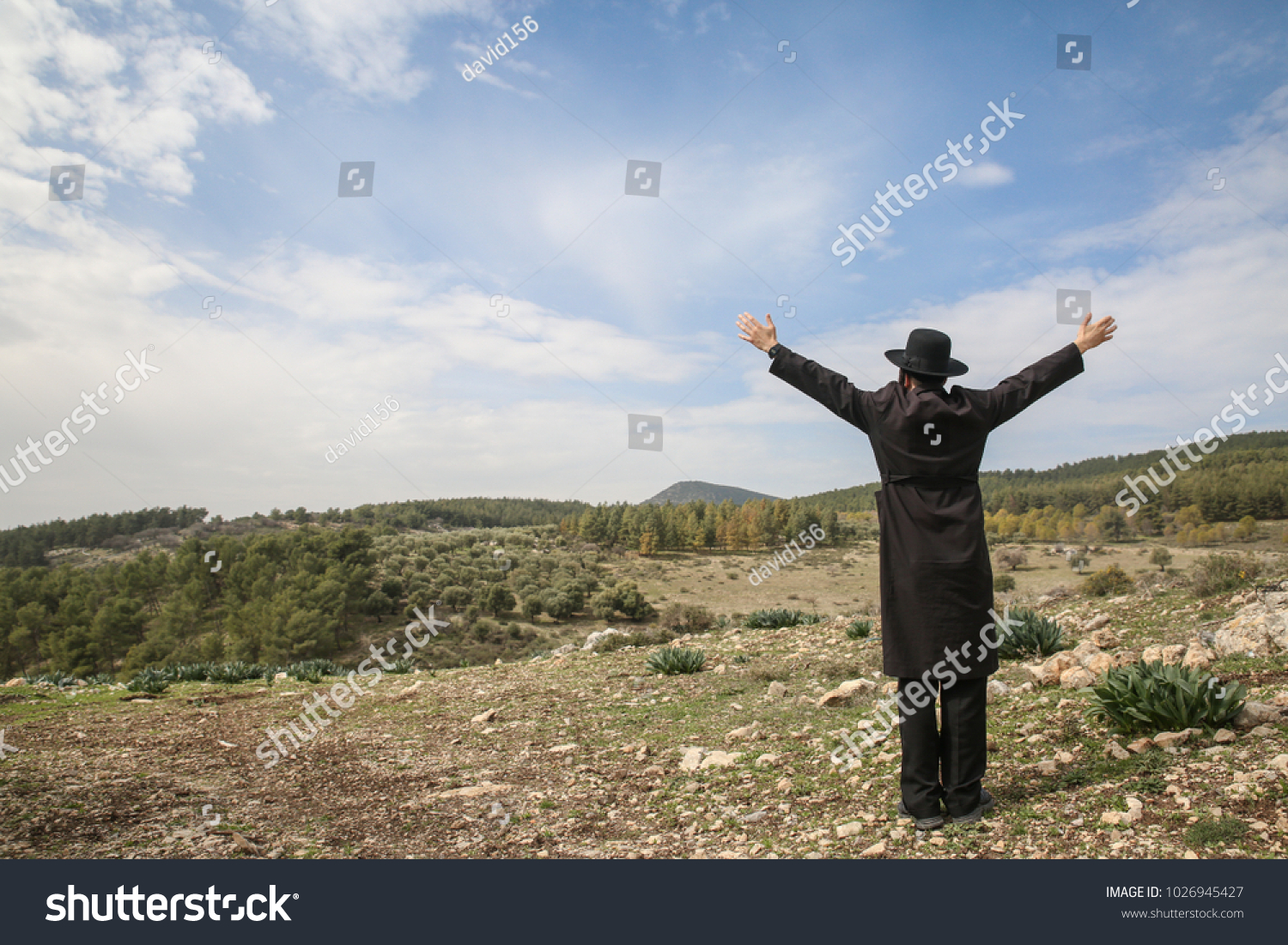 stock-photo-man-raises-his-hands-to-the-sky-imploring-and-seeking-god-1026945427.jpg