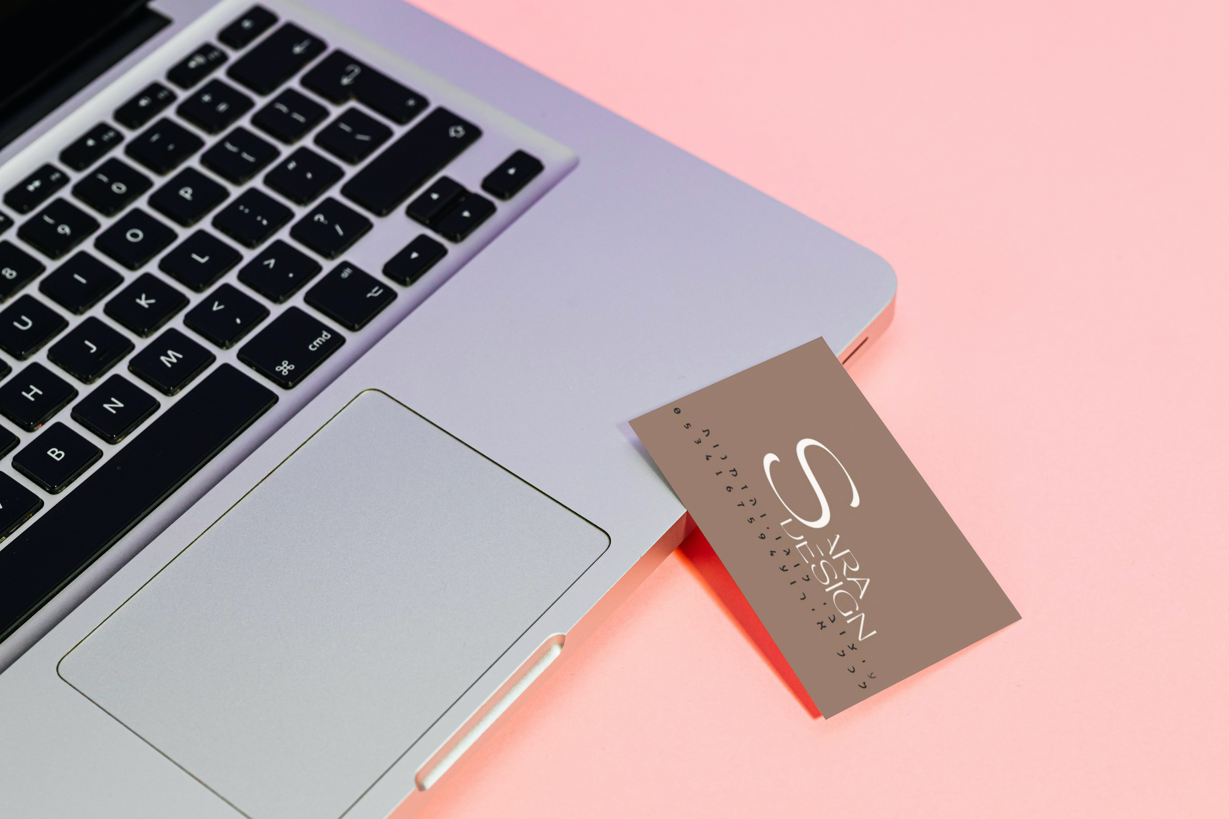 Business card on the laptop on the pink surface_sara.png