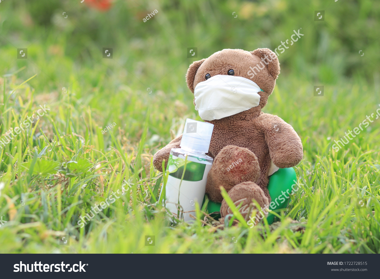 stock-photo-a-bear-doll-with-a-mask-sits-on-a-lawn-in-the-garden-and-holds-a-bottle-of-alcohol...jpg
