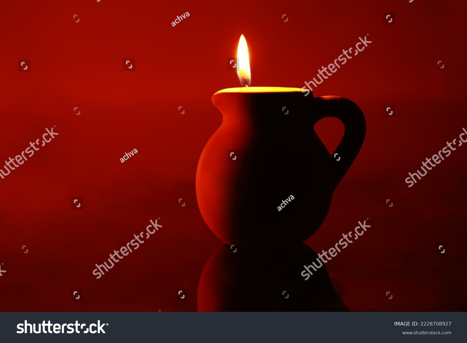stock-photo-a-clay-urn-with-a-candle-lit-inside-2228708927.jpg
