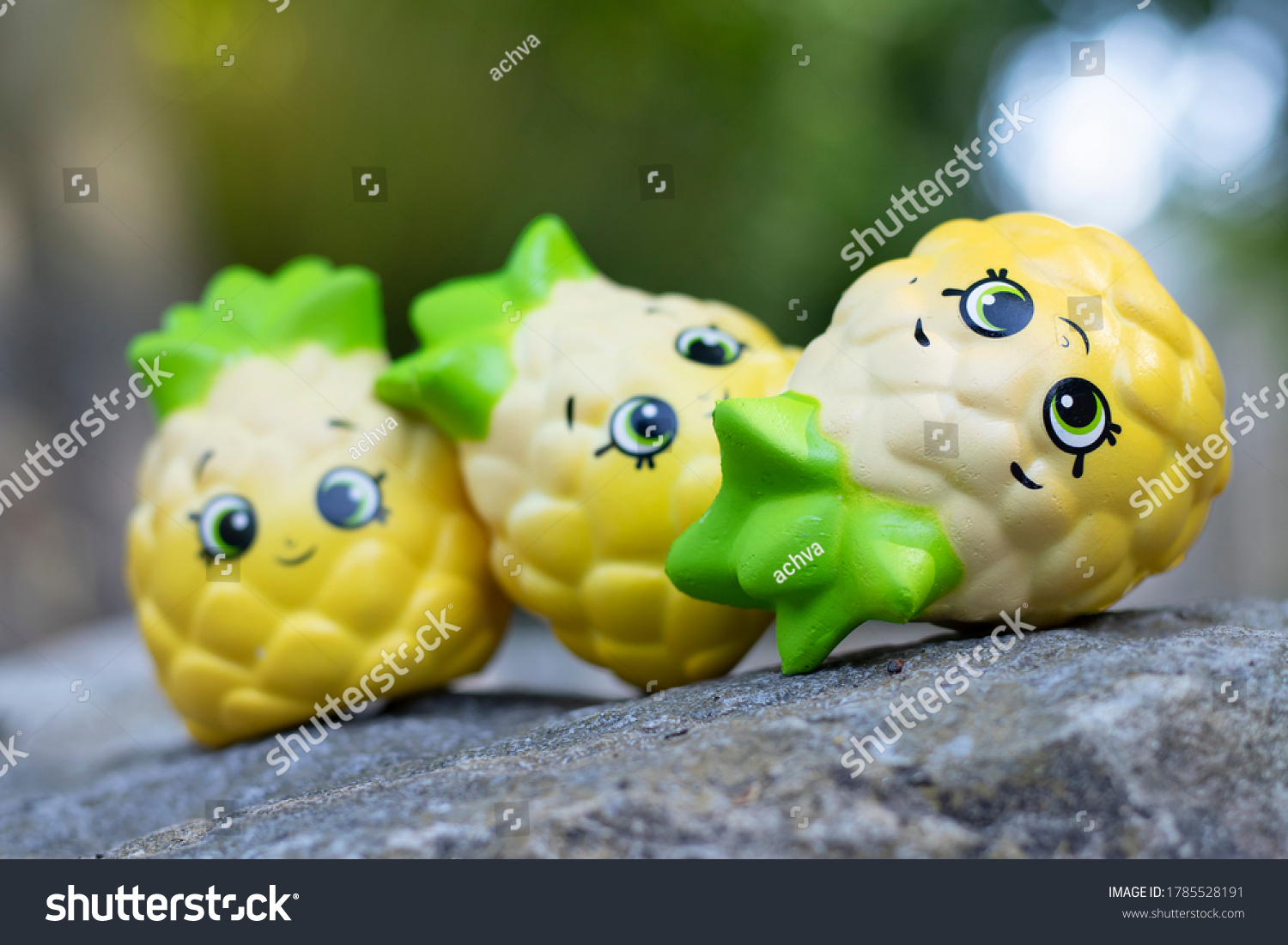 stock-photo--pineapple-toy-dolls-placed-on-a-stone-in-the-garden-1785528191.jpg