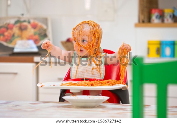 messy-baby-boy-sits-high-600w-1586727142.jpg